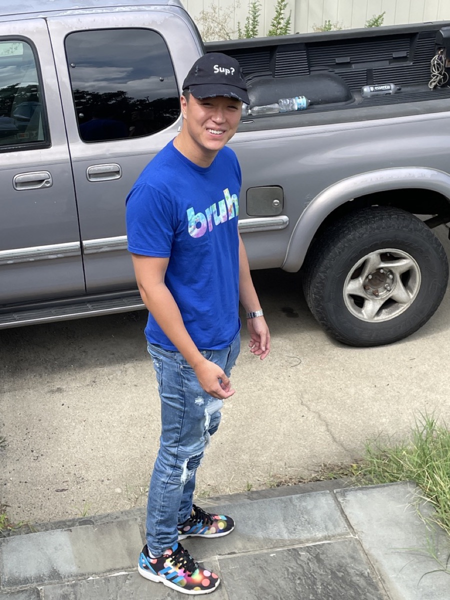 Brandon in the tie-dye costume outfit standing by a truck