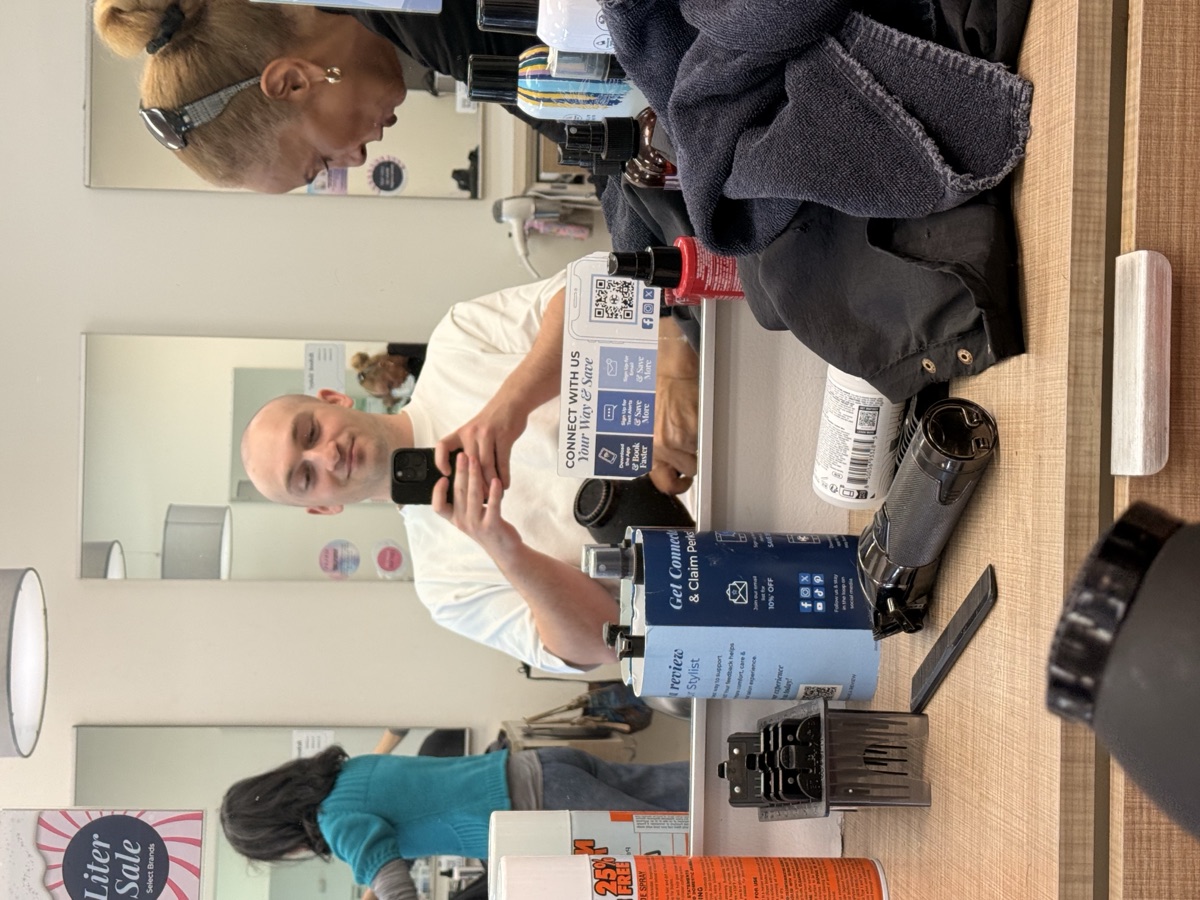 Pige in the salon mirror with the clippers on the counter