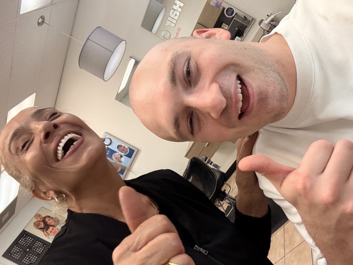 Pige after his head-shave punishment, giving a thumbs up at the salon